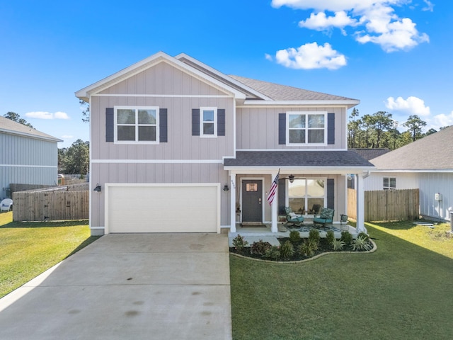 view of front of property featuring a garage, driveway, a front yard, and fence