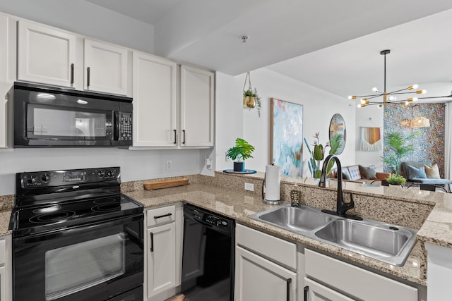 kitchen with white cabinets, kitchen peninsula, sink, and black appliances