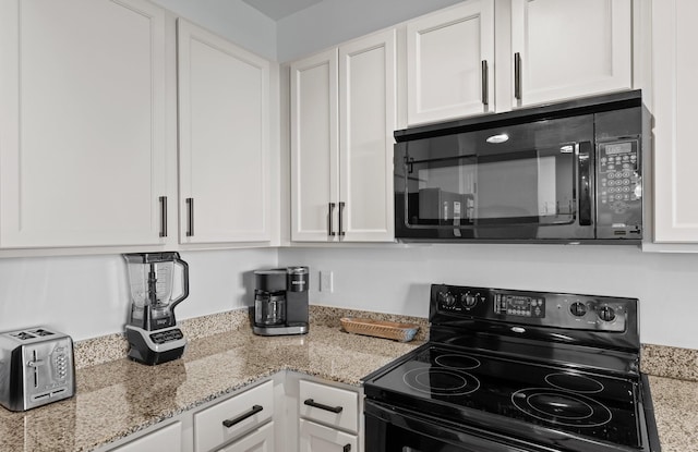 kitchen featuring white cabinets, light stone countertops, and black appliances