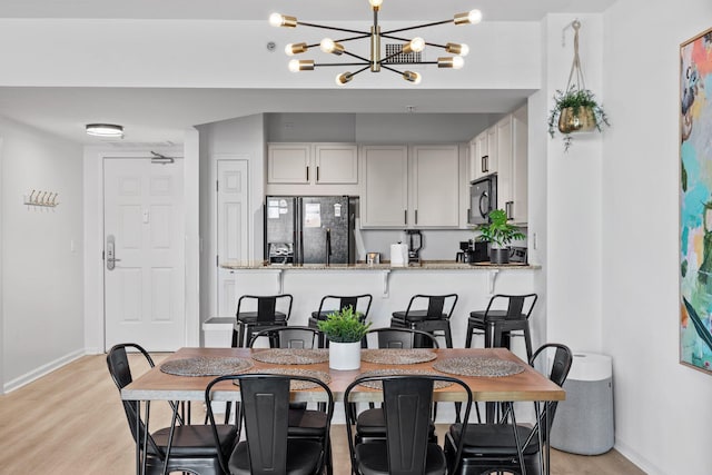 dining space with light wood-type flooring