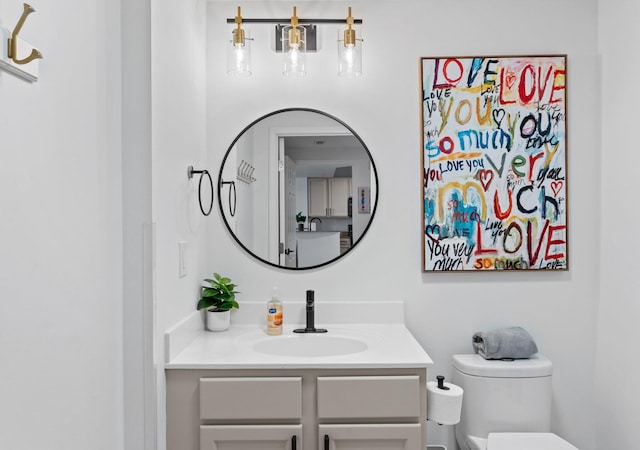 bathroom featuring vanity and toilet