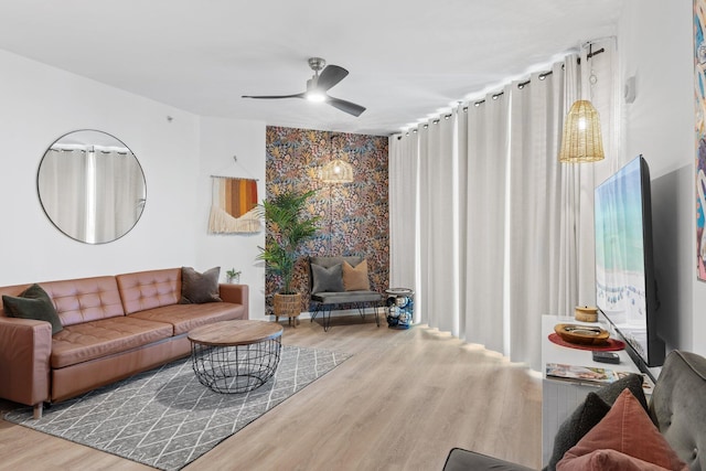 living room with hardwood / wood-style flooring and ceiling fan