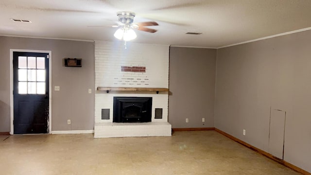 unfurnished living room featuring ceiling fan, a brick fireplace, crown molding, and a textured ceiling