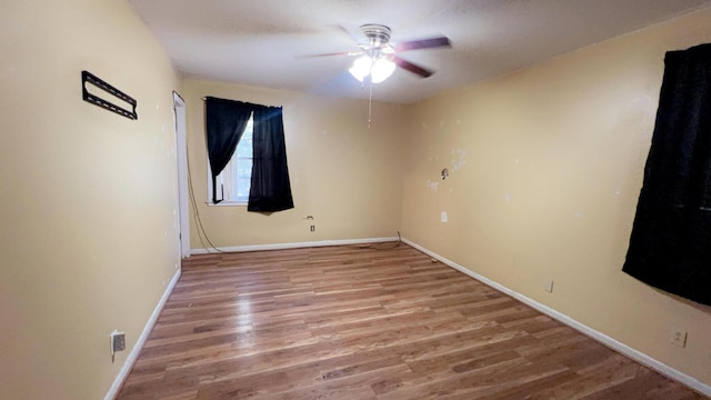 spare room with ceiling fan and wood-type flooring