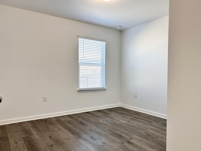 spare room featuring dark hardwood / wood-style floors