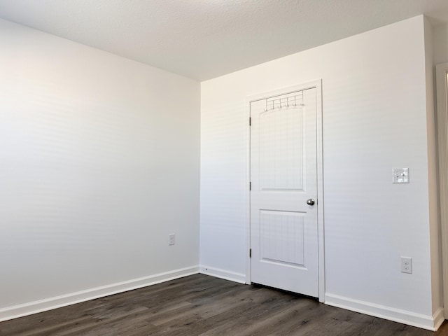 unfurnished room with dark hardwood / wood-style floors