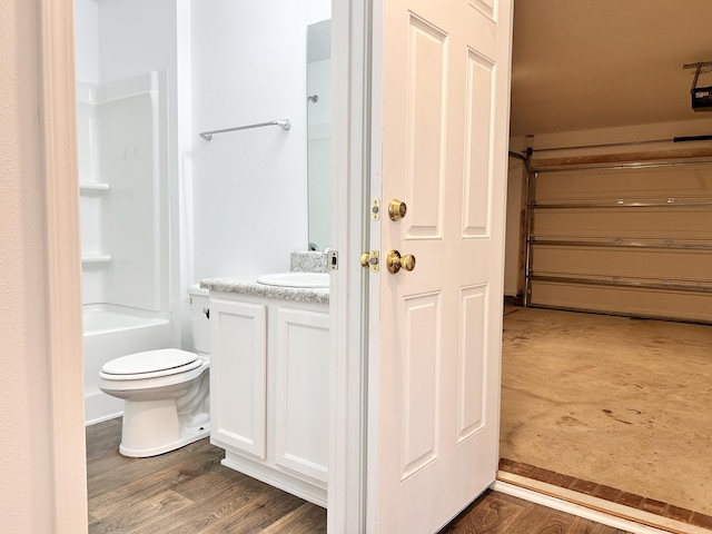 bathroom featuring vanity, hardwood / wood-style floors, and toilet