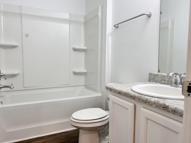 full bathroom with vanity, bathtub / shower combination, hardwood / wood-style floors, and toilet