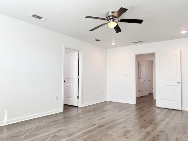 empty room featuring hardwood / wood-style floors and ceiling fan