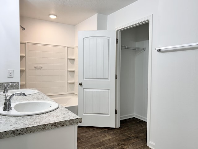 bathroom with vanity, hardwood / wood-style floors, and a textured ceiling