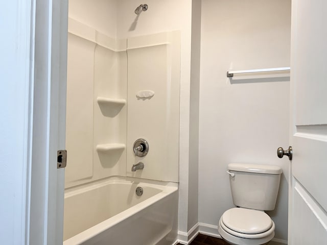 bathroom featuring shower / tub combination and toilet