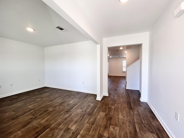 unfurnished room with dark hardwood / wood-style floors