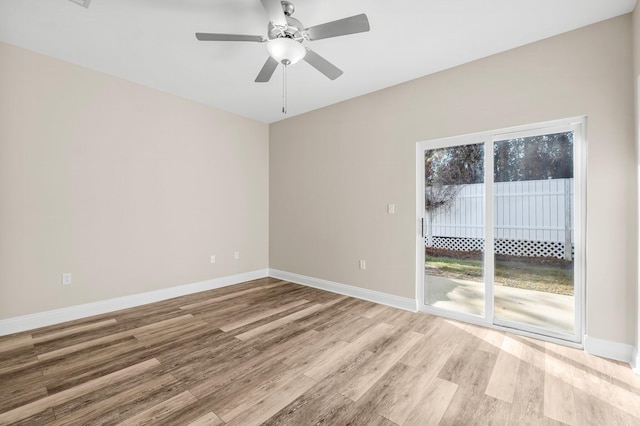 spare room with light wood-type flooring and ceiling fan