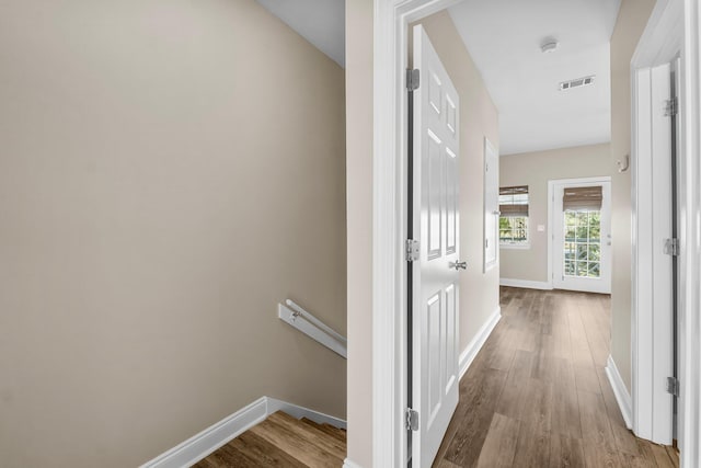 hall with hardwood / wood-style floors