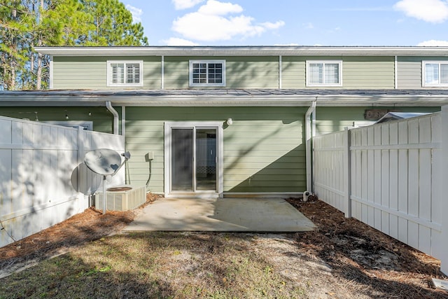 rear view of property featuring central AC and a patio area