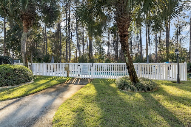 exterior space featuring a yard and a fenced in pool