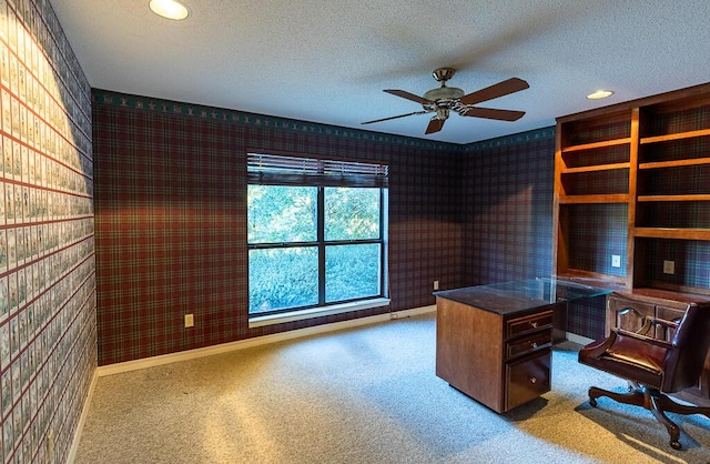 unfurnished office with ceiling fan, carpet floors, and a textured ceiling