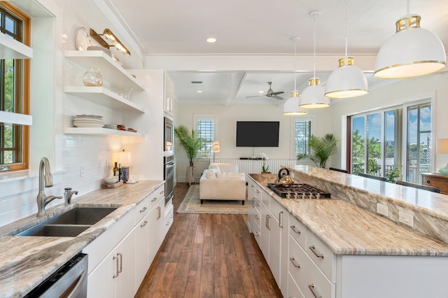 kitchen featuring beamed ceiling, pendant lighting, sink, white cabinetry, and tasteful backsplash