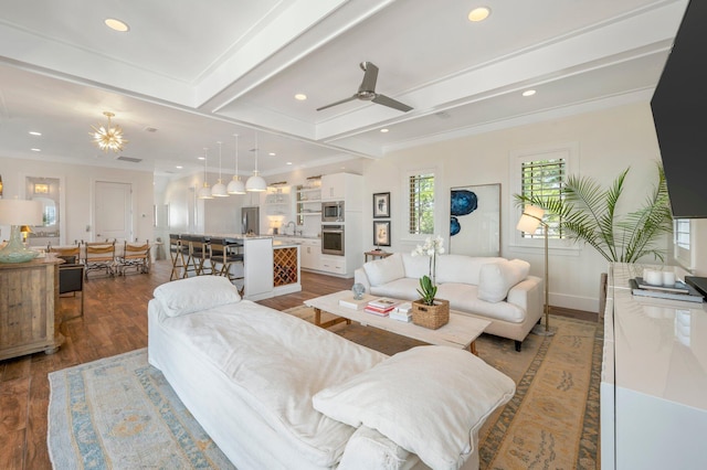 living room with wood-type flooring, ceiling fan, ornamental molding, beam ceiling, and sink