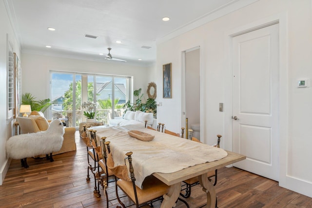 dining area featuring dark hardwood / wood-style flooring, ceiling fan, and crown molding