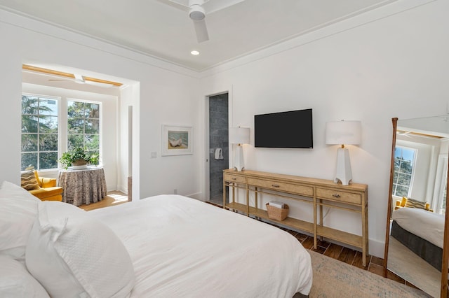 bedroom with hardwood / wood-style flooring, ceiling fan, crown molding, and multiple windows