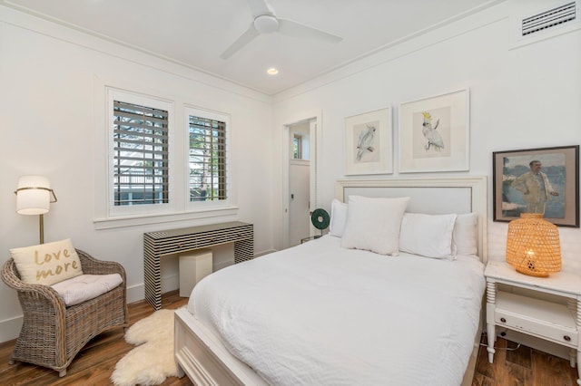 bedroom with ceiling fan, dark wood-type flooring, and crown molding