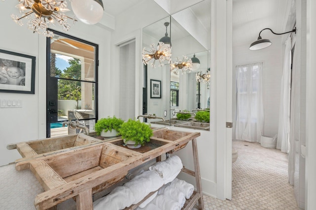 bathroom featuring toilet and a notable chandelier