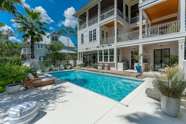 view of swimming pool featuring a patio and ceiling fan