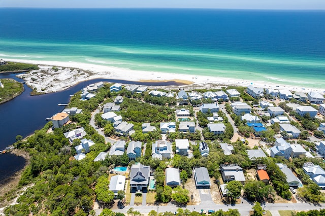 birds eye view of property with a beach view and a water view