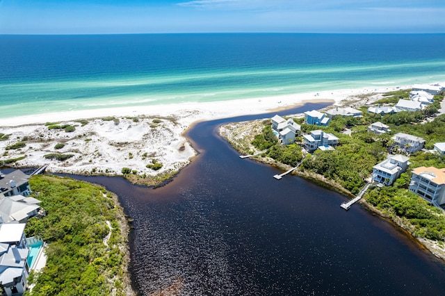 birds eye view of property with a view of the beach and a water view