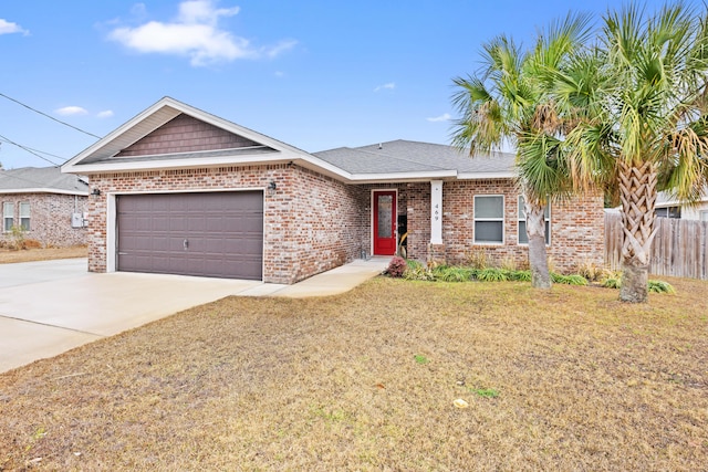 view of front of property featuring a garage and a front lawn