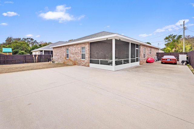 rear view of house with a patio and a sunroom