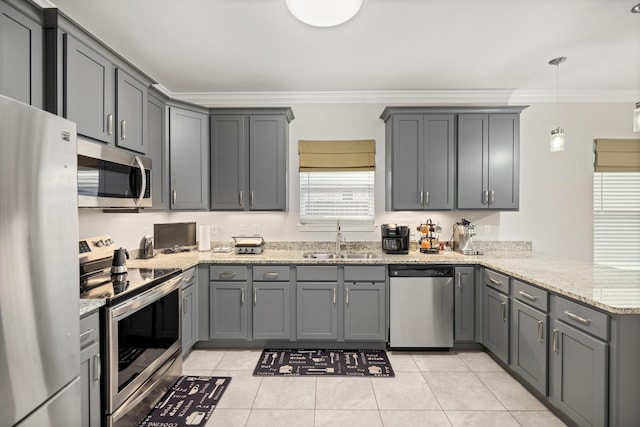 kitchen featuring appliances with stainless steel finishes, pendant lighting, and gray cabinetry