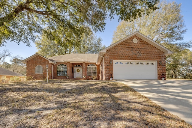 ranch-style house featuring brick siding, an attached garage, and concrete driveway