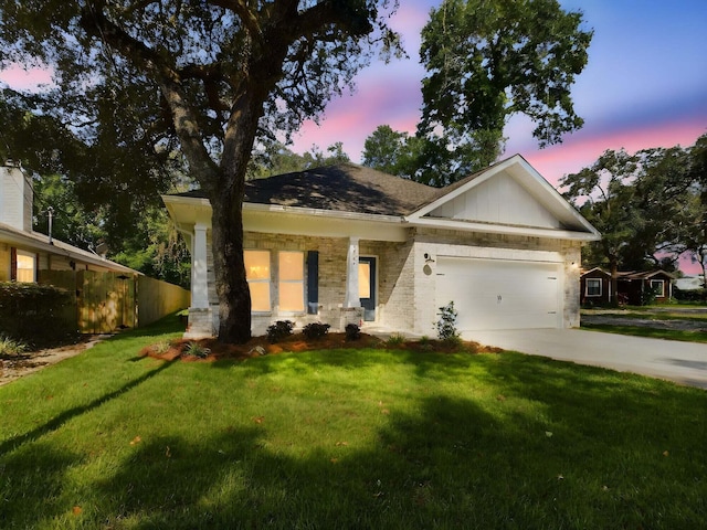 single story home with a garage and a lawn