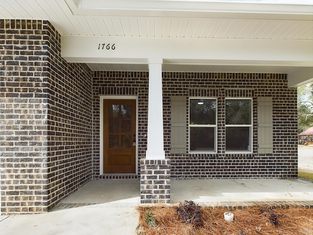 property entrance with brick siding