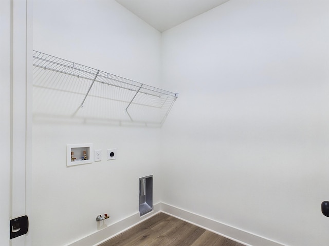 clothes washing area with gas dryer hookup, laundry area, washer hookup, dark wood-style flooring, and baseboards