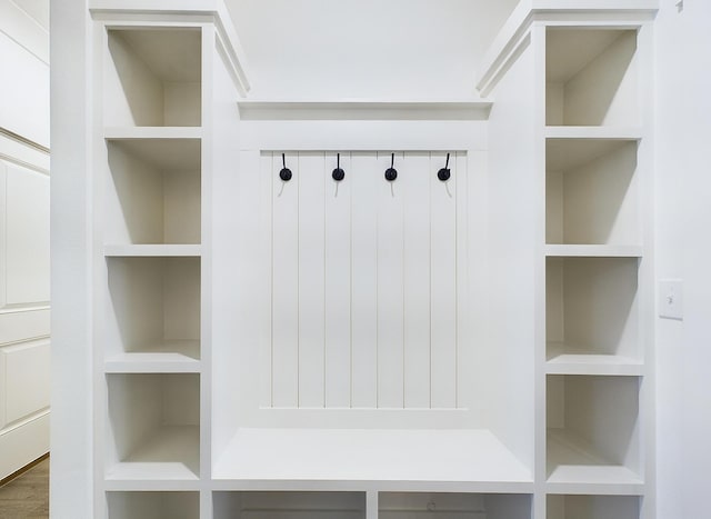 mudroom featuring built in features and wood finished floors