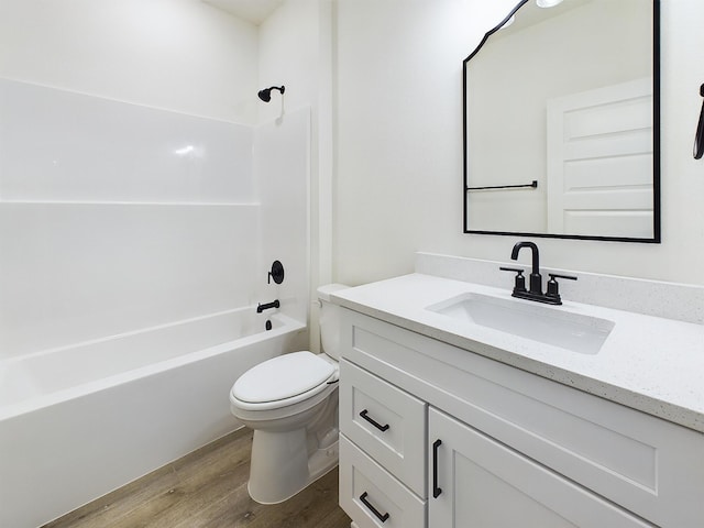 full bathroom featuring vanity, bathing tub / shower combination, wood finished floors, and toilet