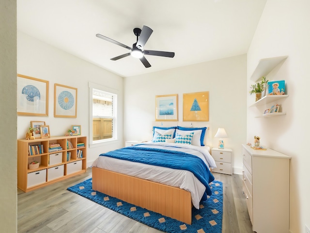 bedroom featuring a ceiling fan and wood finished floors