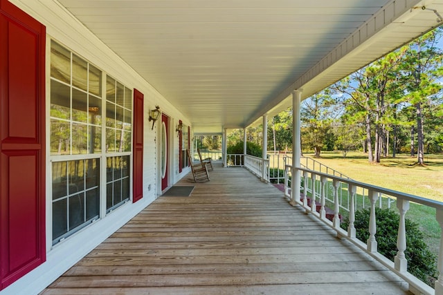 deck with covered porch and a lawn