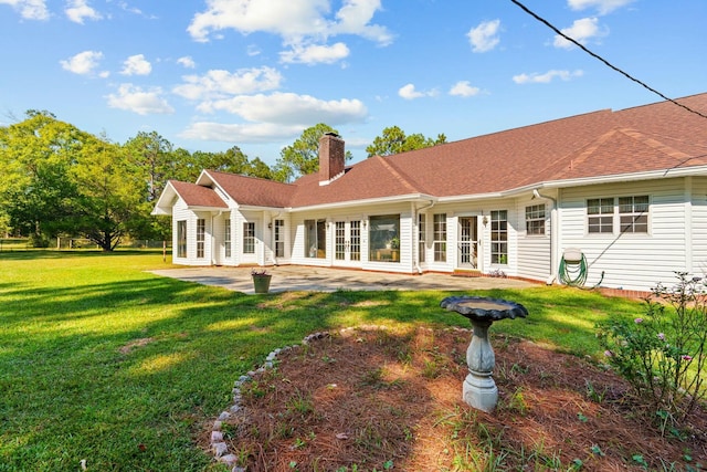 back of house with a patio area and a yard