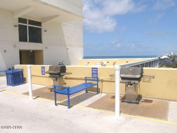 view of patio with a water view and grilling area