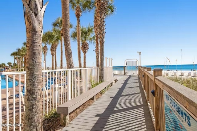 surrounding community with a beach view and a water view