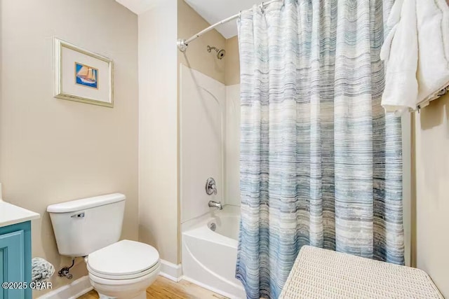 full bathroom with toilet, shower / bath combo with shower curtain, and vanity