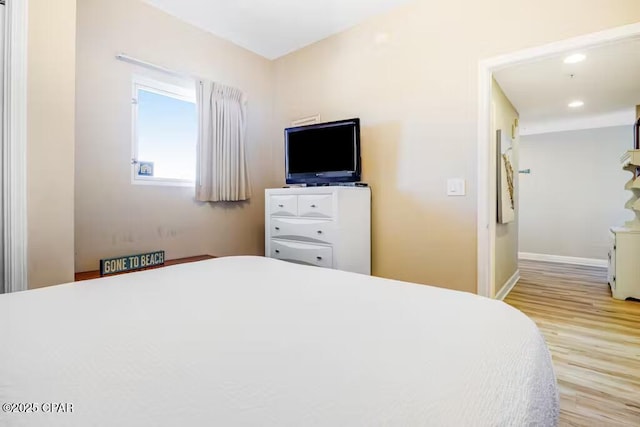 bedroom with light hardwood / wood-style flooring