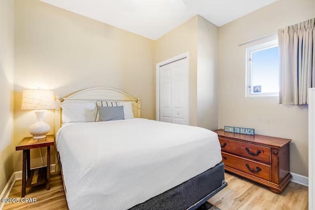 bedroom featuring a closet and light hardwood / wood-style flooring