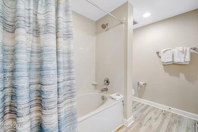 bathroom with wood-type flooring and shower / bath combination with curtain