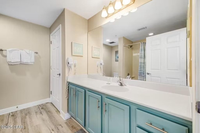 bathroom featuring a shower with curtain, toilet, wood-type flooring, and vanity