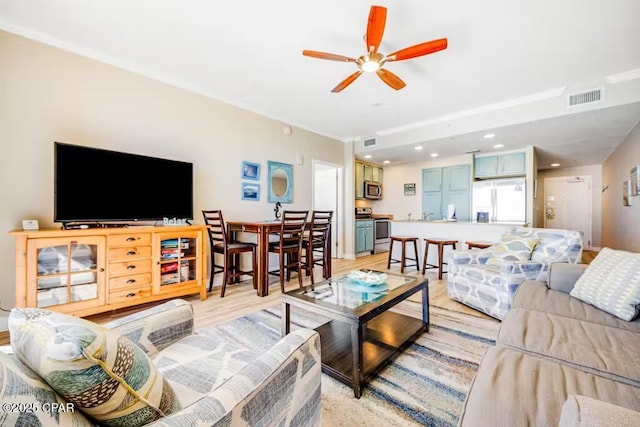 living room with ceiling fan and light hardwood / wood-style floors